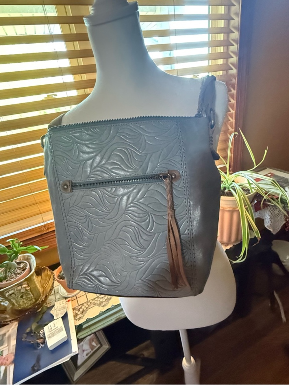 The Sak Ashland Leather Crossbody; color is light blue